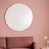 large round wall mirror with a fluted gold metal slim frame