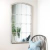 decorative white iron framed window wall mirror with a distressed painted finish