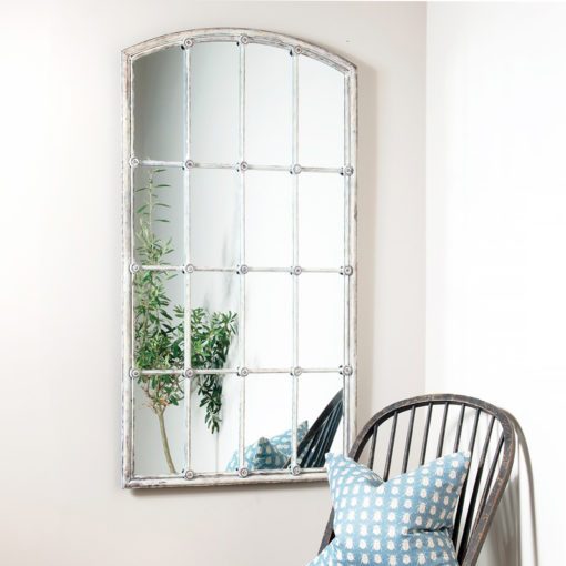 decorative white iron framed window wall mirror with a distressed painted finish