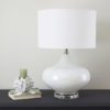 large round white glass table lamp on a round acrylic base and completed with a round white lampshade