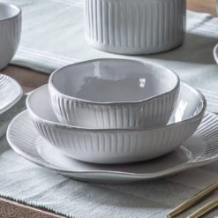 vintage white porcelain plates and bowls with an uneven rustic shape and ribbed edging
