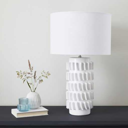 large white table lamp with a textured tiled ceramic base and white drum lampshade