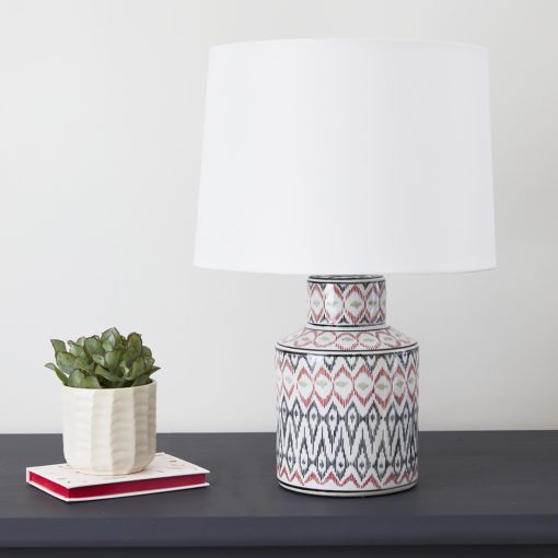 small white porcelain table lamp with Aztec pattern and white lampshade