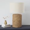 substantial table lamp with a wide cylinder rope base and natural linen lampshade