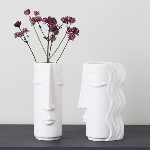 contemporary white ceramic tall vase with a femal face design and long hair