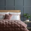 cotton velvet quilted pin-tucked bedspread in blush pink wth a natural cotton linen mix reverse