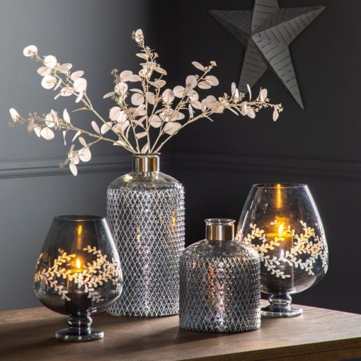 smokey grey glass footed hurricane lanterns and textured bottle vases