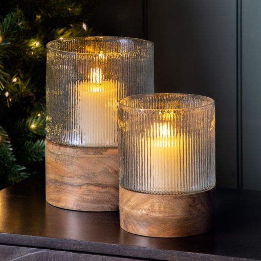 round cylinder hurricane candle holders with a mango wood base and ribbed glass hurricane