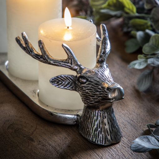 aluminium three pillar candle holder with stag head ends