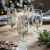 set of four pale green footed tumblers with an etched star design