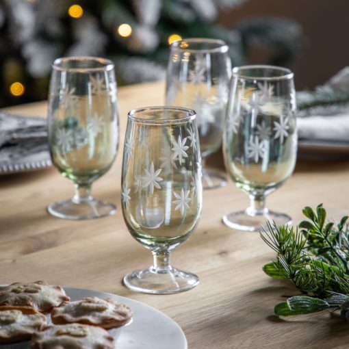 set of four pale green footed tumblers with an etched star design