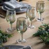 set of four pale green wine glasses with an etched star design