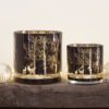 glass candle holders in two sizes with a cut-out woodland scene