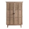 tall wooden cupboard on legs with internal shelving and two panelled doors with rattan detailing and metal handles