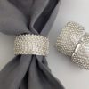 set of four round silver napkin rings encased in diamantes