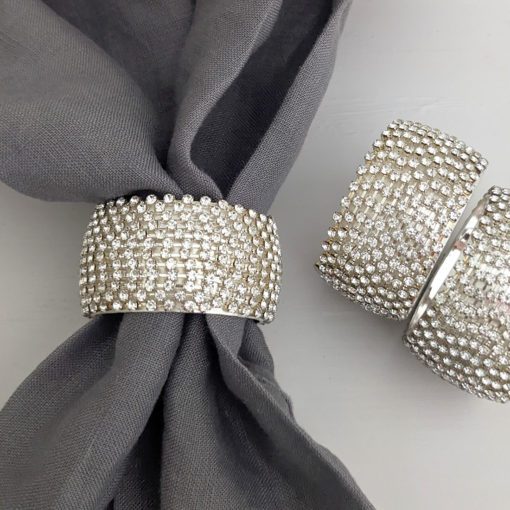 set of four round silver napkin rings encased in diamantes