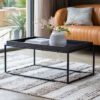 rectangular black metal framed coffee table with a wooden tray table top