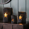 black bamboo candle holders with a cut-out star design and thick rope handle