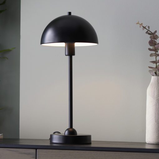 small contemporary black table lamp with a stick base and domed metal shade