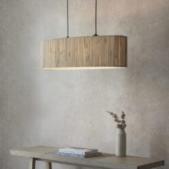 natural woven seagrass linear pendant light suspended from contrasting black cords