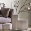 stone coloured cement plant pots available in three sizes with a chunky ribbed design
