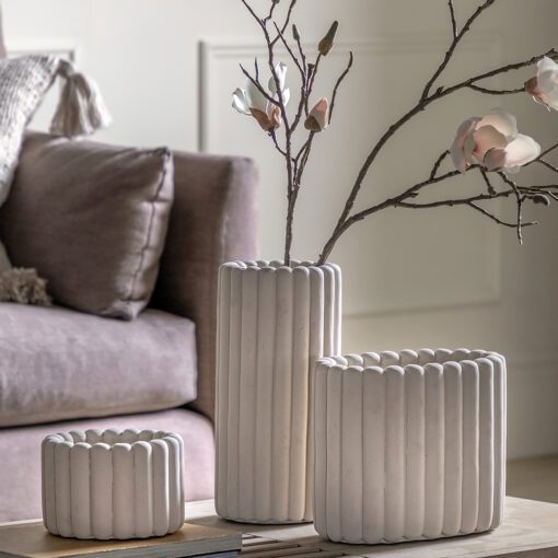 stone coloured cement plant pots available in three sizes with a chunky ribbed design