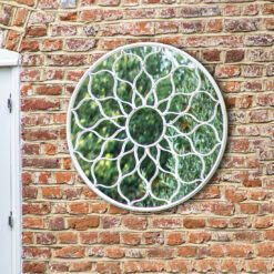 round outdoor garden mirror with a vintage white metal frame and decorative flower design