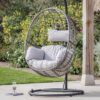 single hanging egg chair with a natural rattan look and showerproof deep cushions