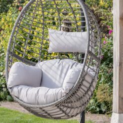 single hanging egg chair with a natural rattan look and showerproof deep cushions