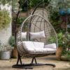 double hanging cocoon chair with a natural rattan look and deep showerproof cushions