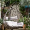 double hanging cocoon chair with a natural rattan look and deep showerproof cushions