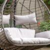 double hanging cocoon chair with a natural rattan look and deep showerproof cushions