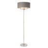 polished silver stemmed floor lamp with a three-arm light fitting and grey linen lampshade