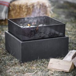 contemporary round outdoor fire pit with a punched metal bowl placed on a grey fibre clay square base