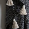 woven black and cream cotton mix cosy throw with large cream tassels