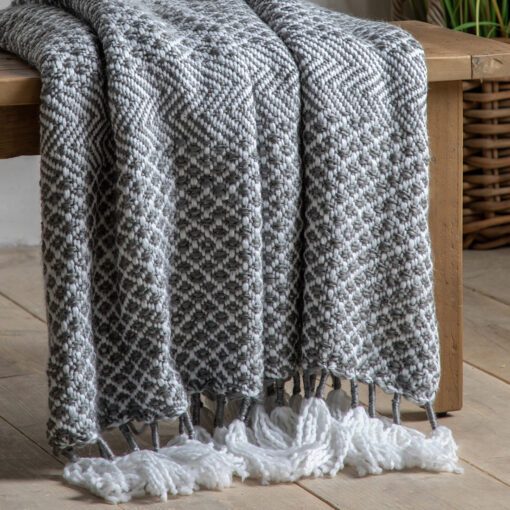 textured grey and cream woven throw with long cream tassels