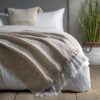 textured natural and cream woven throw with long cream tassels