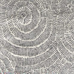 rectangular cream rug with a striking inky grey swirly starburst design