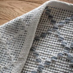 large cream rug with a grey harlequin diamond pattern