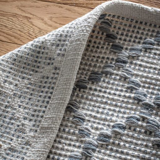 large cream rug with a grey harlequin diamond pattern