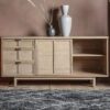sold ash wooden sideboard with three drawers and two cupboards with a panelled ratten cane door detail