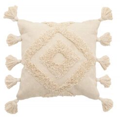 large cream cushion with a textured tufted diamond pattern and large pom pom edges