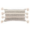 large rectangular cream cushion with a stitched black linear detailing and large cream pom pom edges