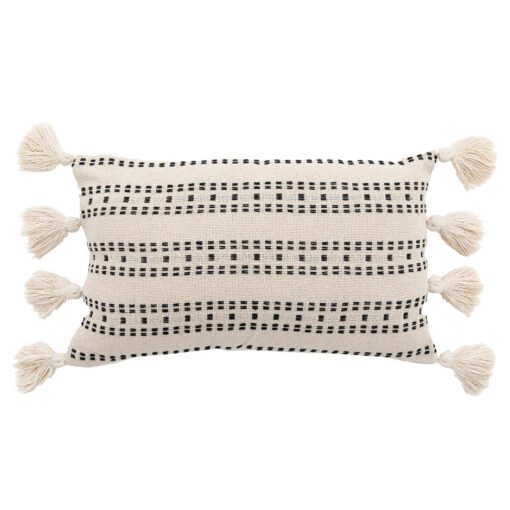 large rectangular cream cushion with a stitched black linear detailing and large cream pom pom edges