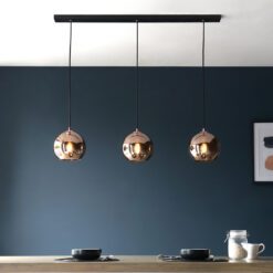 black linear light with three suspended round pendants with a mirrored copper finish