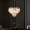 large art deco style twelve pendant chandelier with layers of clear glass ribbed glass tubes suspended from a silver steel frame and adjustable chain