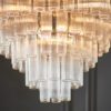 large art deco style twelve pendant chandelier with layers of clear glass ribbed glass tubes suspended from a silver steel frame and adjustable chain