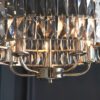 bright nickel plated drum pendant lights available in two sizes with clear glass faceted shades and adjustable chains