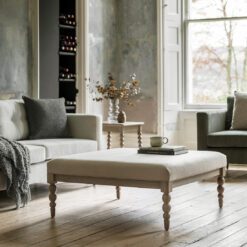 handcrafted square oak coffee table with bobbin turned legs and a natural upholstered top