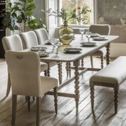 handcrafted extendable oak rectangle dining table seating eight people with decorative bobbin legs